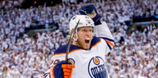 Patrik Laine Free Agency: 4 Teams Linked to Pending NHL UFA Conceptual action photo of NHL player Patrik Laine celebrating wildly in an Edmonton Oilers white away jersey and helmet, illustrating potential Free Agency landing spots for the pending UFA.