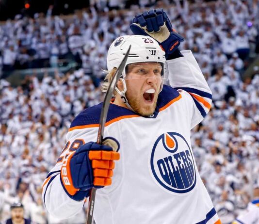 Patrik Laine Free Agency: 4 Teams Linked to Pending NHL UFA Conceptual action photo of NHL player Patrik Laine celebrating wildly in an Edmonton Oilers white away jersey and helmet, illustrating potential Free Agency landing spots for the pending UFA.