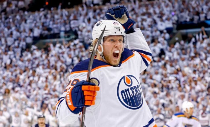 patrik-laine-montreal-canadiens-nhl-free-agent Conceptual action photo of NHL player Patrik Laine celebrating wildly in an Edmonton Oilers white away jersey and helmet, illustrating potential Free Agency landing spots for the pending UFA.