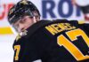 A conceptual image visualizing New Jersey Devils defenseman Simon Nemec wearing a black Pittsburgh Penguins home jersey and helmet, illustrating current NHL trade rumors.