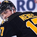 A conceptual image visualizing New Jersey Devils defenseman Simon Nemec wearing a black Pittsburgh Penguins home jersey and helmet, illustrating current NHL trade rumors.