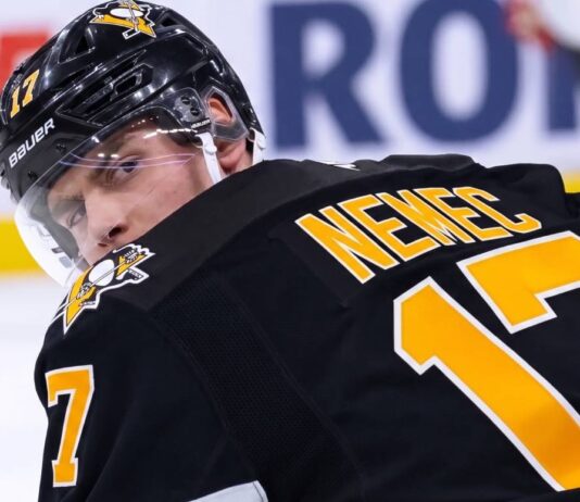 A conceptual image visualizing New Jersey Devils defenseman Simon Nemec wearing a black Pittsburgh Penguins home jersey and helmet, illustrating current NHL trade rumors.