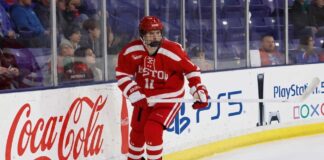 Tynan Lawrence, Boston University center and St. Louis Blues 2026 draft prospect, in action on the ice wearing jersey #11.