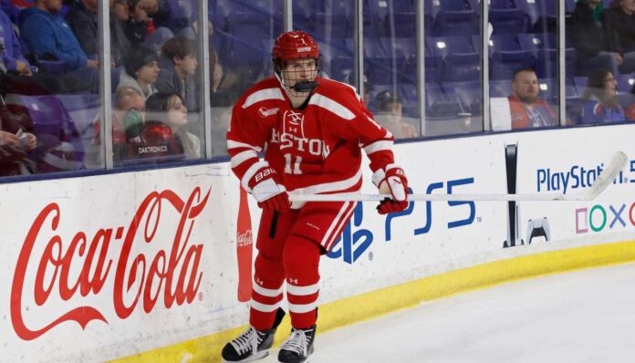 tynan-lawrence-st-louis-blues-draft Tynan Lawrence, Boston University center and St. Louis Blues 2026 draft prospect, in action on the ice wearing jersey #11.