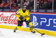 Why the Seattle Kraken Should Draft Viggo Bjorck #7 Overall | Stats & Fit Viggo Björck, a top prospect for the Seattle Kraken in the 2026 NHL Draft, skating with the puck in his yellow Team Sweden number 21 jersey during an international game.