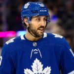 Toronto Maple Leafs Trade Rumors: Vincent Trocheck & NY Rangers An action shot of Vincent Trocheck wearing a blue Toronto Maple Leafs jersey and helmet, skating on the ice at Scotiabank Arena in this conceptual trade rumor image.