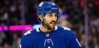 Toronto Maple Leafs Trade Rumors: Vincent Trocheck & NY Rangers An action shot of Vincent Trocheck wearing a blue Toronto Maple Leafs jersey and helmet, skating on the ice at Scotiabank Arena in this conceptual trade rumor image.