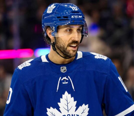 Toronto Maple Leafs Trade Rumors: Vincent Trocheck & NY Rangers An action shot of Vincent Trocheck wearing a blue Toronto Maple Leafs jersey and helmet, skating on the ice at Scotiabank Arena in this conceptual trade rumor image.