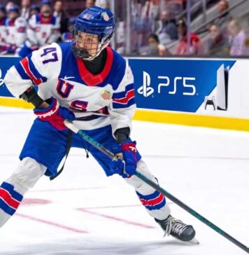 USNTDP forward Wyatt Cullen, a top 2026 NHL Draft prospect for the Nashville Predators, controls the puck during a game.