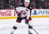 Zach Werenski Trade Rumors: Will the Columbus Blue Jackets Move Him? Zach Werenski, Columbus Blue Jackets star defenseman, during an NHL game, seen in his white away jersey. The photo captures him looking ahead, the primary focus of growing trade speculation for the team.