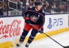 Will Zach Werenski Request a Trade From the Columbus Blue Jackets? Columbus Blue Jackets defenseman Zach Werenski skating in action during an NHL game, the subject of recent trade rumors regarding his future in Columbus.