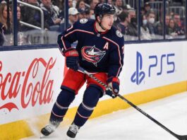 Columbus Blue Jackets defenseman Zach Werenski skating in action during an NHL game, the subject of recent trade rumors regarding his future in Columbus.