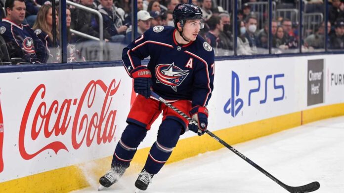 zach-werenski-columbus-blue-jackets-trade-rumors Columbus Blue Jackets defenseman Zach Werenski skating in action during an NHL game, the subject of recent trade rumors regarding his future in Columbus.