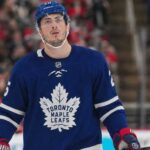 Zach Werenski wearing a Toronto Maple Leafs home jersey in NHL trade rumor image linking the Columbus Blue Jackets defenseman to Toronto