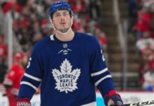 Zach Werenski wearing a Toronto Maple Leafs home jersey in NHL trade rumor image linking the Columbus Blue Jackets defenseman to Toronto