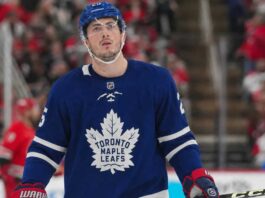 Zach Werenski wearing a Toronto Maple Leafs home jersey in NHL trade rumor image linking the Columbus Blue Jackets defenseman to Toronto
