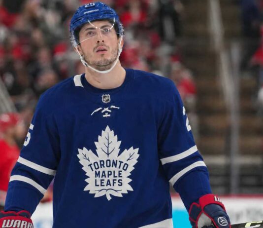 Zach Werenski wearing a Toronto Maple Leafs home jersey in NHL trade rumor image linking the Columbus Blue Jackets defenseman to Toronto