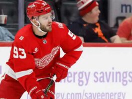Alex DeBrincat skating for the Detroit Red Wings as contract extension and NHL trade rumors surround his future in Detroit