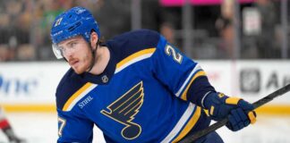 Alexander Nikishin pictured in a St. Louis Blues home jersey amid trade rumors linking the Carolina Hurricanes defenseman to St. Louis.