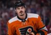 Arber Xhekaj wearing a Philadelphia Flyers home jersey amid NHL trade rumors involving the Montreal Canadiens.