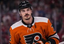 Arber Xhekaj wearing a Philadelphia Flyers home jersey amid NHL trade rumors involving the Montreal Canadiens.