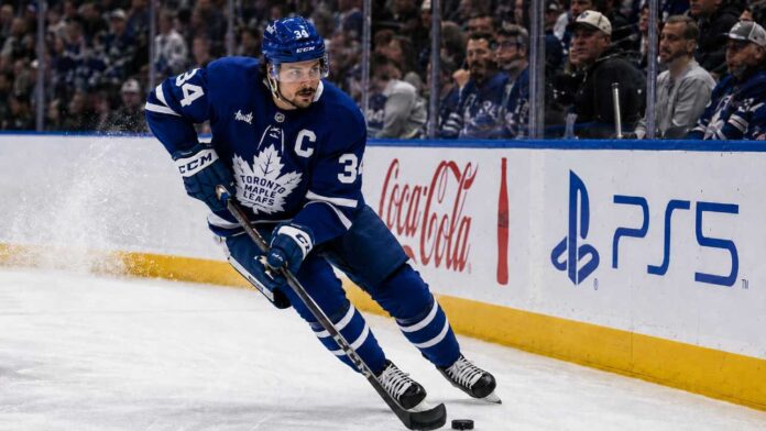 auston-matthews-2026-27-fantasy-point-projection Auston Matthews skating in a Toronto Maple Leafs home jersey with the captain’s C during the 2026-27 NHL season.