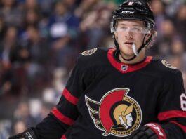 Brock Boeser wearing an Ottawa Senators home jersey amid NHL trade rumors linking the Vancouver Canucks winger to Ottawa