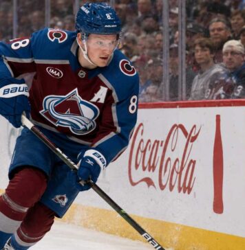Cale Makar skating for the Colorado Avalanche as a right-shot defenseman beside Coca-Cola and Nintendo Switch board ads during a 2026-27 Fantasy Hockey projection.