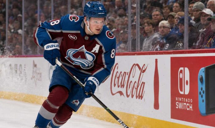 Cale Makar skating for the Colorado Avalanche as a right-shot defenseman beside Coca-Cola and Nintendo Switch board ads during a 2026-27 Fantasy Hockey projection.