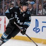Clayton Keller Point Projections 2026-27: Is a 95-Point Season Coming? Clayton Keller skating in a Utah Mammoth home jersey during a 2026-27 fantasy hockey projection predicting 30 goals, 65 assists and 95 points.