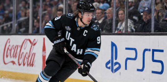 Clayton Keller Point Projections 2026-27: Is a 95-Point Season Coming? Clayton Keller skating in a Utah Mammoth home jersey during a 2026-27 fantasy hockey projection predicting 30 goals, 65 assists and 95 points.