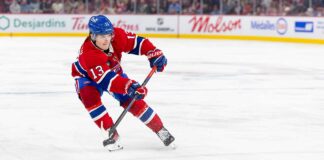 Cole Caufield Fantasy Hockey Projection: Goals, Assists and Points for 2026-27 Cole Caufield skating in a Montreal Canadiens home jersey beside Coca-Cola and PS5 board ads for a 2026-27 Fantasy Hockey projection.
