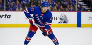 Connor Zary wearing a New York Rangers home jersey amid NHL trade rumors linking the Calgary Flames forward to New York