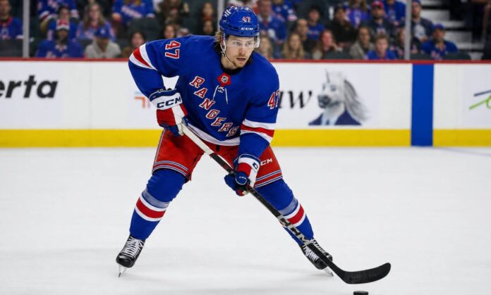 connor-zary-calgary-flames-new-york-rangers-trade-rumors Connor Zary wearing a New York Rangers home jersey amid NHL trade rumors linking the Calgary Flames forward to New York