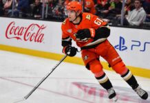 Cutter Gauthier skating for the Anaheim Ducks beside Coca-Cola and PS5 rink-board ads amid NHL contract rumors