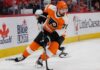 Dylan Larkin wearing a Philadelphia Flyers home jersey amid trade speculation involving the Detroit Red Wings