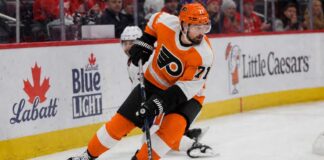 Dylan Larkin wearing a Philadelphia Flyers home jersey amid trade speculation involving the Detroit Red Wings