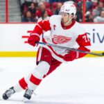 Dylan Larkin skating in a Detroit Red Wings away jersey amid NHL trade rumors linking the Red Wings captain to Philadelphia