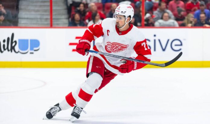 Dylan Larkin skating in a Detroit Red Wings away jersey amid NHL trade rumors linking the Red Wings captain to Philadelphia