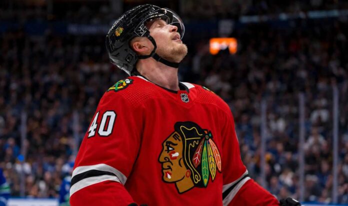 elias-pettersson-chicago-blackhawks-trade-rumors Elias Pettersson wearing a Chicago Blackhawks home jersey and helmet amid NHL trade rumors involving the Vancouver Canucks