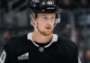 Elias Pettersson wearing a Los Angeles Kings home jersey and helmet amid trade speculation involving the Vancouver Canucks