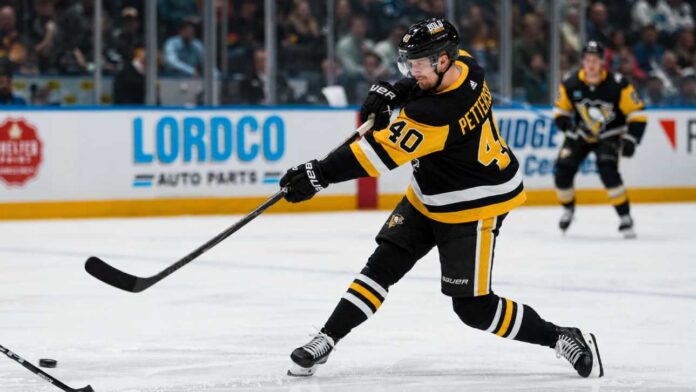 elias-pettersson-pittsburgh-penguins-rumors Elias Pettersson wearing a Pittsburgh Penguins home jersey while taking a powerful shot during an NHL game