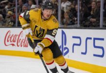 Jack Eichel Fantasy Hockey Projection: Will He Reach 100 Points in 2026-27? Jack Eichel skating for the Vegas Golden Knights beside Coca-Cola and PS5 rink-board ads during his projected 2026-27 Fantasy Hockey season.