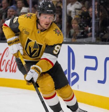 Jack Eichel Fantasy Hockey Projection: Will He Reach 100 Points in 2026-27? Jack Eichel skating for the Vegas Golden Knights beside Coca-Cola and PS5 rink-board ads during his projected 2026-27 Fantasy Hockey season.