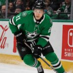 Jason Robertson Point Projections 2026-27: Will the Dallas Stars Star Reach 100? Jason Robertson skating in a Dallas Stars home jersey beside Coca-Cola and Nintendo Switch rink board ads for his 2026-27 fantasy hockey projection