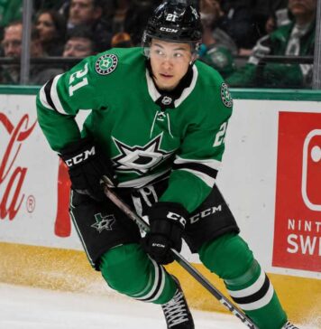 Jason Robertson Point Projections 2026-27: Will the Dallas Stars Star Reach 100? Jason Robertson skating in a Dallas Stars home jersey beside Coca-Cola and Nintendo Switch rink board ads for his 2026-27 fantasy hockey projection
