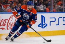 Leon Draisaitl Point Projections 2026-27: Can He Reach 120 Points? Leon Draisaitl skating in an Edmonton Oilers home jersey during his projected 119-point 2026-27 fantasy hockey season