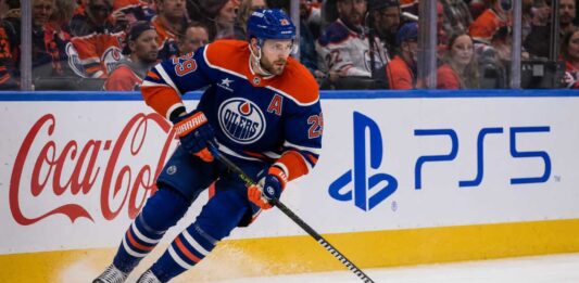 Leon Draisaitl Point Projections 2026-27: Can He Reach 120 Points? Leon Draisaitl skating in an Edmonton Oilers home jersey during his projected 119-point 2026-27 fantasy hockey season