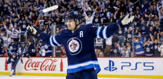 Mark Scheifele Point Projections 2026-27: Winnipeg Jets Fantasy Hockey Outlook Mark Scheifele celebrates for the Winnipeg Jets with Coca-Cola and PS5 board ads in a 2026-27 fantasy hockey point projections preview
