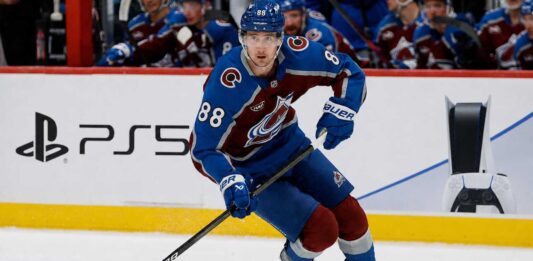 Martin Necas Point Projections 2026-27: Colorado Avalanche Fantasy Outlook Martin Necas skates for the Colorado Avalanche beside a PS5 rink-board ad ahead of his 2026-27 fantasy hockey point projection.